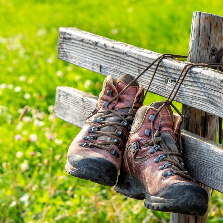 Two boots tied to a bench