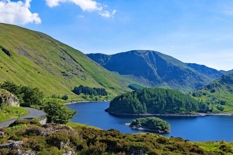 Haweswater reservoir looking at the water and surrounding green mountains