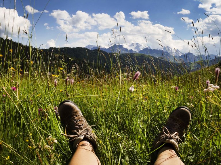 feet with boots on relaxing in long grass