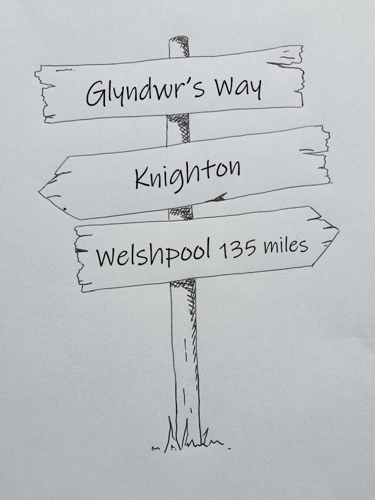 Hand drawn sign post showing Glyndwr's Way, Knighton to Welshpool 135 miles 